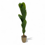 An artificial banana tree with big leaves and a golden basin