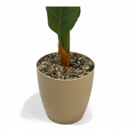 An artificial banana tree with big leaves and a golden basin