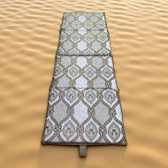 Comfortable foldable mattress with a multi-colored strap.