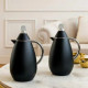 A luxurious black tea and coffee thermos set with silver handles.