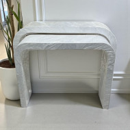 A stylish and modern entryway set featuring a contemporary and minimalist design with a distinctive white U-shaped edge.