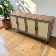 A unique wooden buffet cabinet with four doors, featuring a stylish design in light brown.