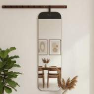 A modern, full-length wall mirror with a wooden shelf and hanging hooks.