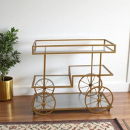 A stylish and elegant display stand with a gold-tone glass top.