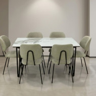 A luxurious beige dining table for six, featuring a stunning, high-gloss ceramic surface built to withstand daily use with ease.